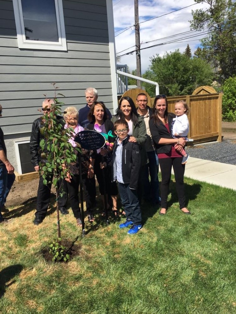 Kandice's family gathered around a memorial tree.